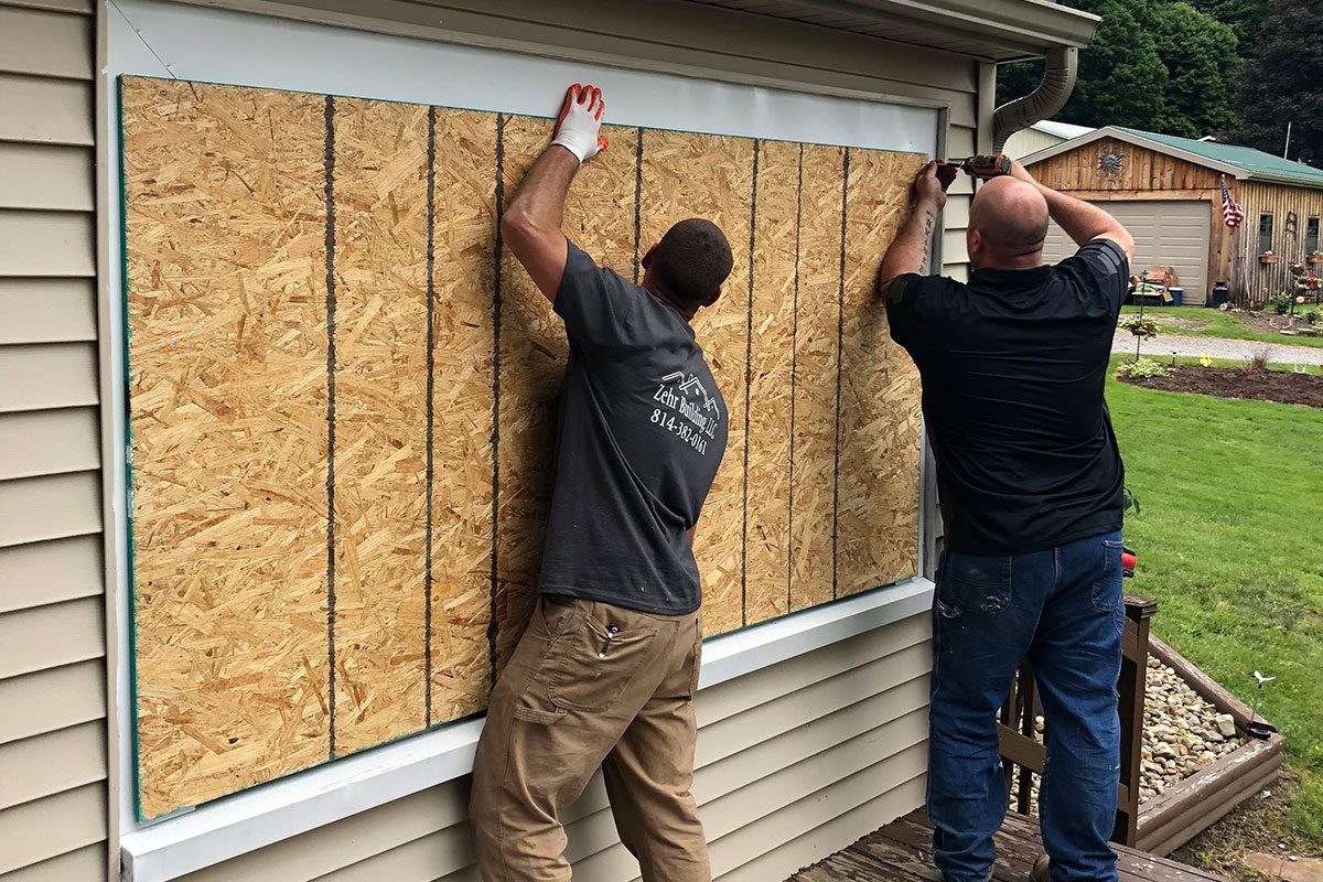 Zehr Restorations crew boards up windows after a house fire