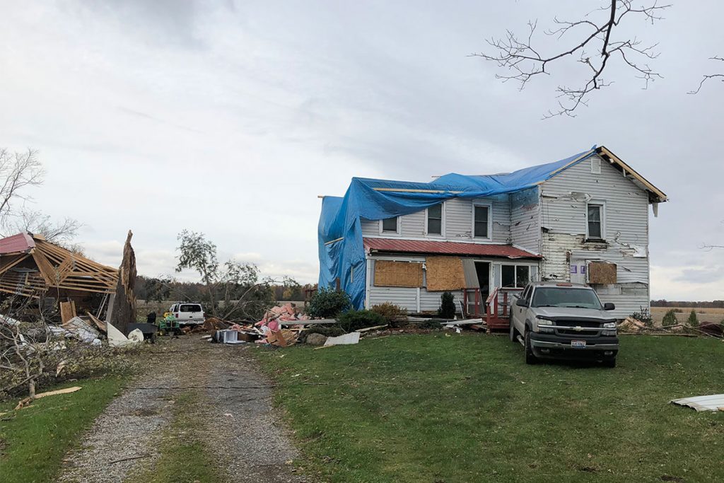 Emergency tarp services at this storm-damaged house